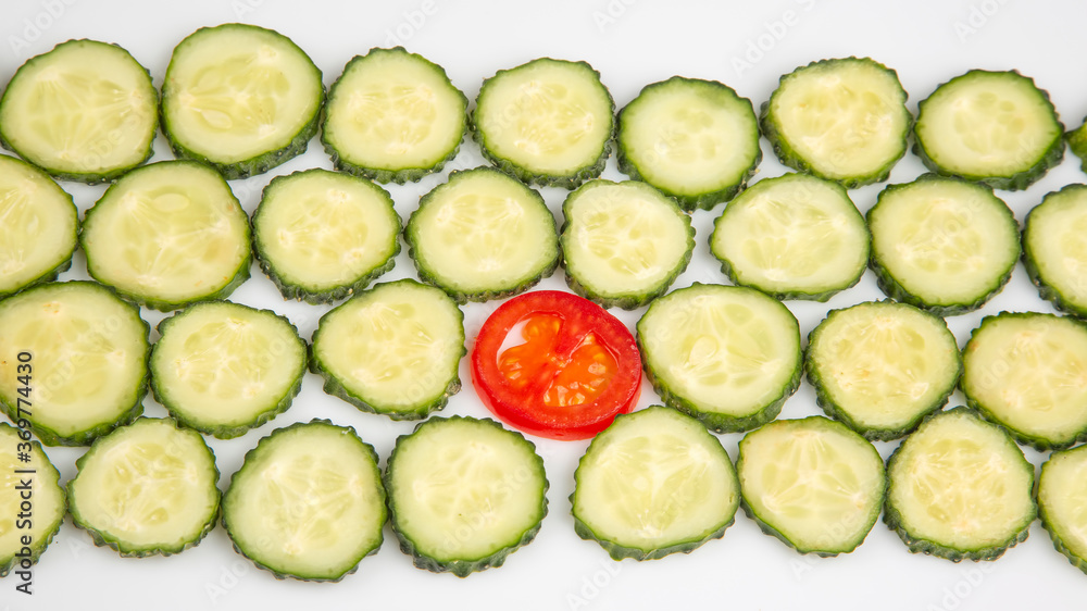 sliced pieces of cucumber and tomato on a white background. fast food and breakfast sliced pieces of cucumber and tomato on a white background. fast food and breakfast