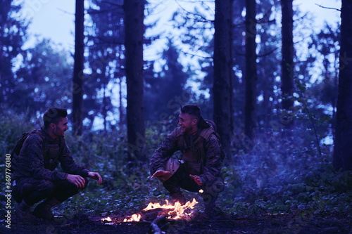 soldiers resting by fire in forest
