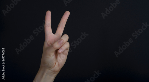 Hand gesture on a dark background