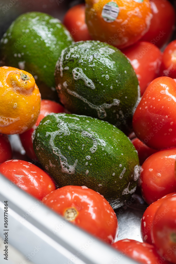 Washing fruits and vegetables with soap in home. Stock Photo Adobe Stock