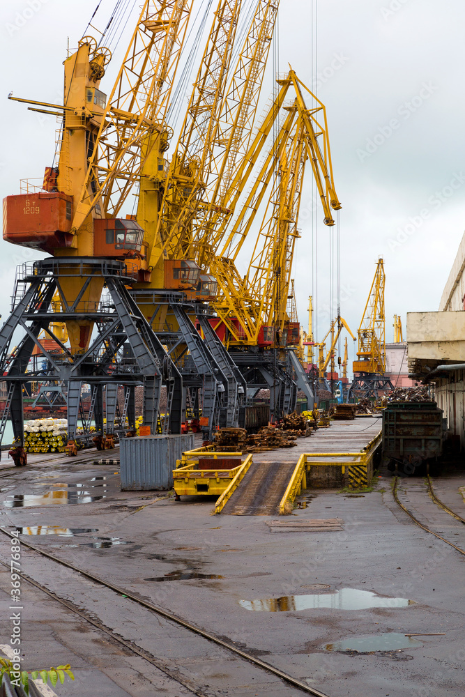 Odessa, Ukraine - October 13, 2016: Container cranes in cargo port terminal, cargo cranes without job in an empty harbor port. A crisis. Defaulted paralyzed entire economy