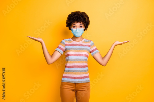 Portrait of her she nice healthy wavy-haired girl nurse wearing safety mask holding copy space on palms mers cov influenza concept isolated bright vivid shine vibrant yellow color background photo