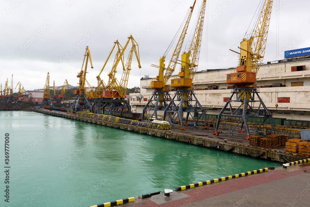 Odessa, Ukraine - October 13, 2016: Container cranes in cargo port terminal, cargo cranes without job in an empty harbor port. A crisis. Defaulted paralyzed entire economy
