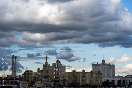 high-rise buildings reflections of sky and clouds and pre-storm sky in summer © константин константи