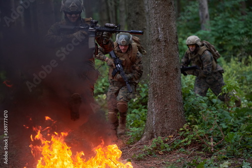 Soldier in Action at Night jumping over fire