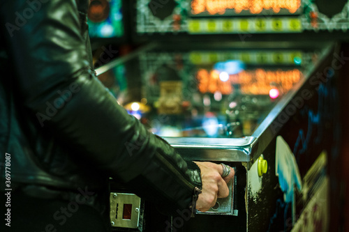 Tableau sur toile Young woman playing on the pinball machine