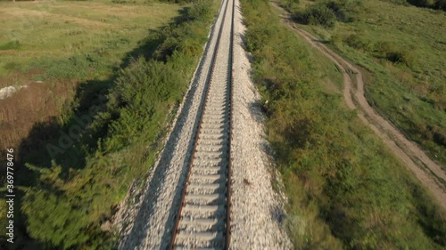 Fast aerial pan up of a long railway track in Serbia near Novi Becej. photo