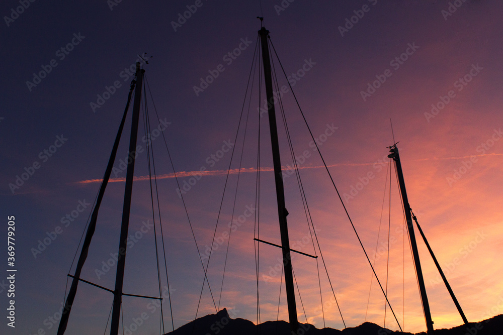 sailing boats silhouette in the orange summer sunset