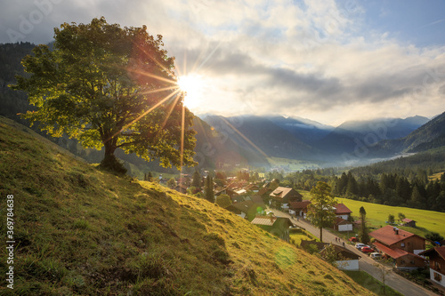 Beautiful sunrise over the alpine village of Hinterstein in German Bavaria photo