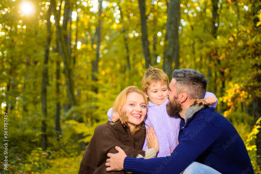 Happy family in autumn park. Autumn Family. Family parenthood and people concept - happy mother father and little boy in autumn park. Happy family together in yellow nature.