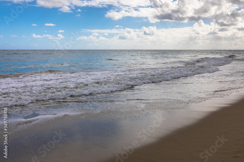 Fototapeta Naklejka Na Ścianę i Meble -  Water rolling on a golden sand beach, Dominican Republic, Caribbean