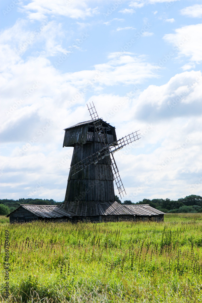 old abandoned wooden windmill in the field