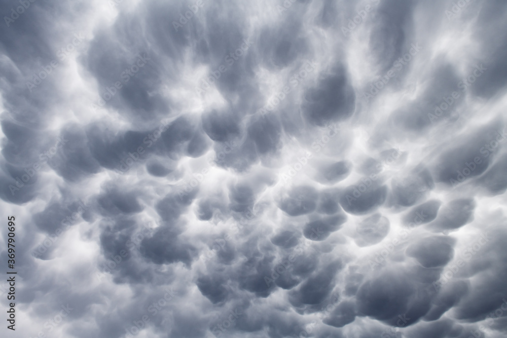Fototapeta premium Stormy sky with menacing mammatus clouds before the storm. Climate change nature background