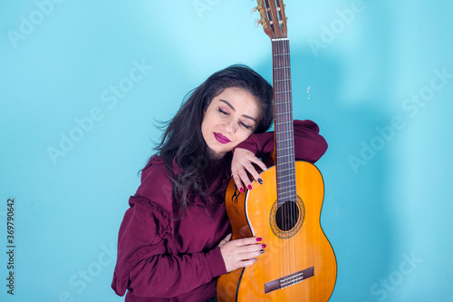 young woman sleeping on her guitar © Vahagn