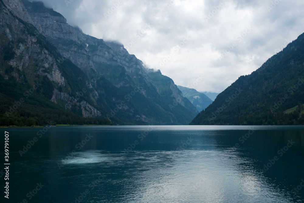 The lake Kloental in Switzerland, Glarus on a cloudy day day, copyspace between mountains, moody picture