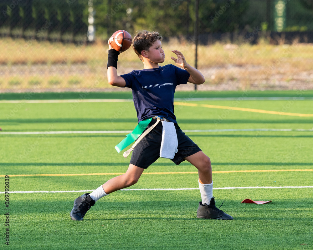 Young athletic boy playing in a flag football game Young athletic boy playing in a flag football game