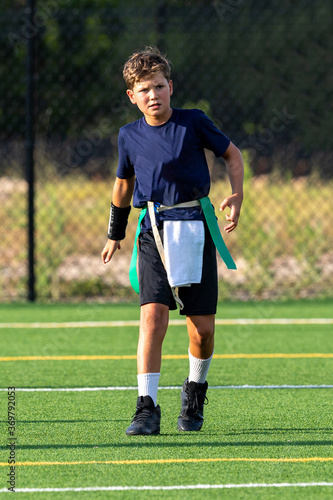 Young athletic boy playing in a flag football game