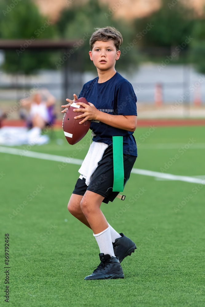 Obraz premium Young athletic boy playing in a flag football game
