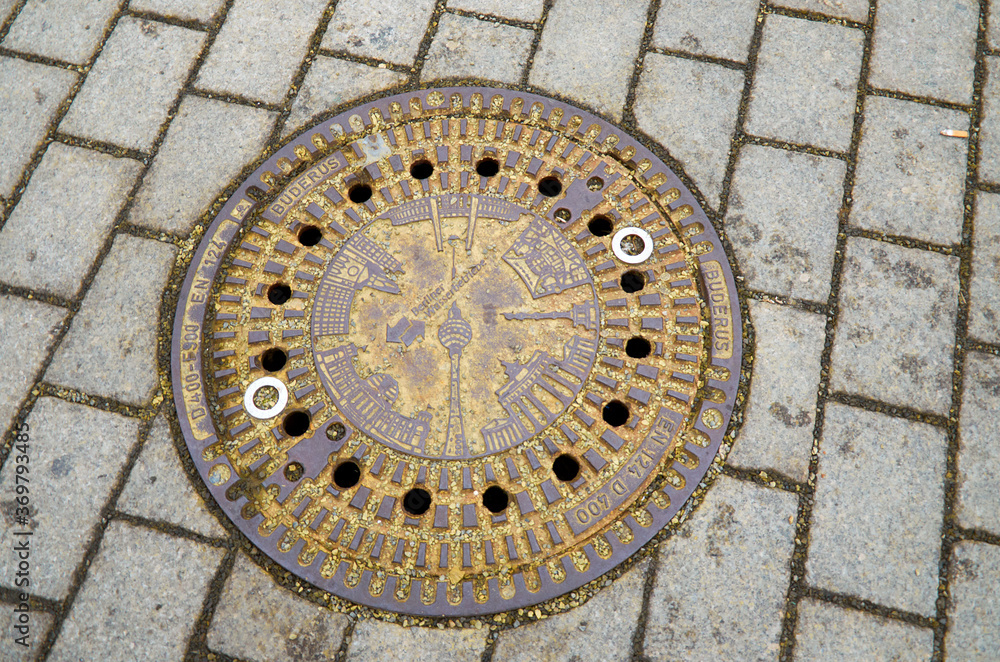 Germany. Berlin. Sewer manhole on the street of Berlin. February 17, 2018