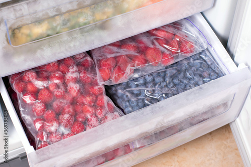 Frozen berries in plastic bags in the freezer