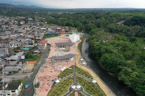 Aerial view of a small park at the edge of a small village next to the rainforest