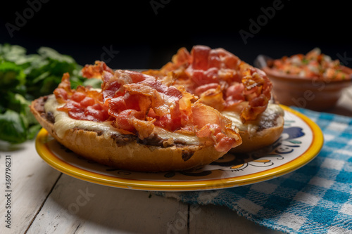 Mexican molletes with bacon and pico de gallo sauce on white background