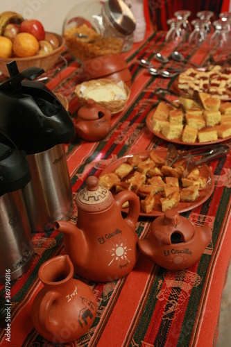 A buffet table with small snacks, coffee and tea and local handicrafts