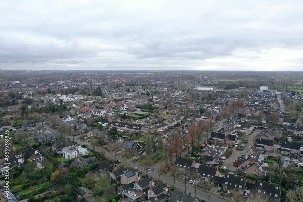 Aerial view of a small city in Europe with neat rows of moderately big houses