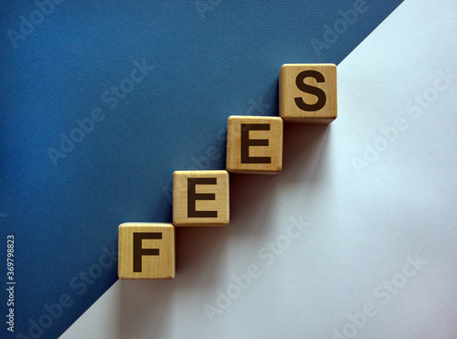 Concept word 'fees' on cubes on a beautiful white and blue background. Business concept. Copy space.