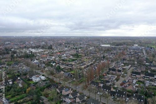 Aerial view of a small city in Europe with neat rows of moderately big houses © pangamedia