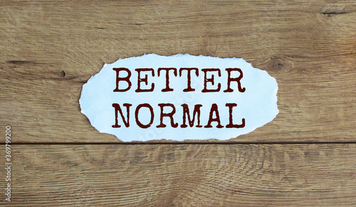 Words 'better normal' on the piece of paper. Wood table. Business concept.