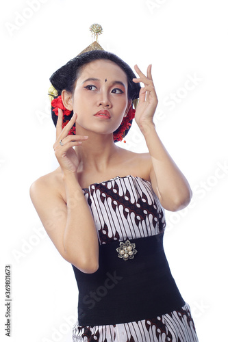 Beautiful Young Woman with bright makeup. a woman using traditional javanese lurik batik and bun on hair