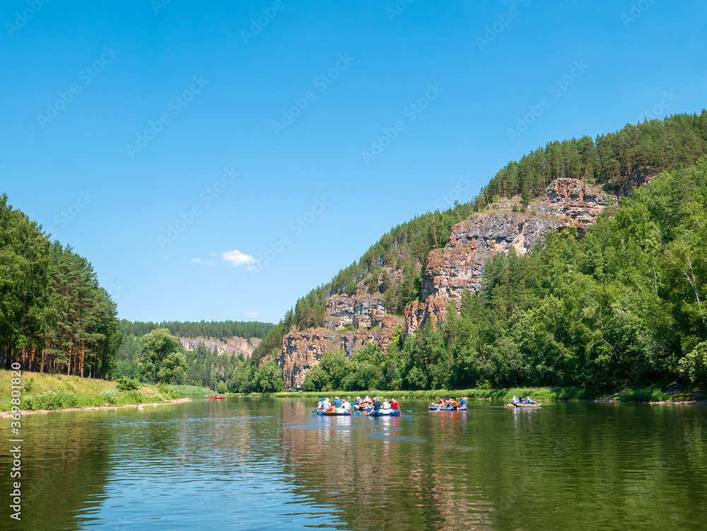 Landscape, river, mountains, forests on a summer day. Rafting down the river.