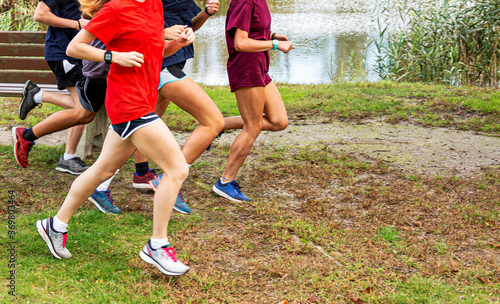 Group of runners training nest to a lake