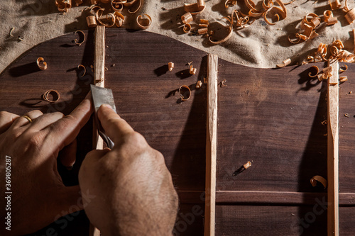Luthier making top of guitar