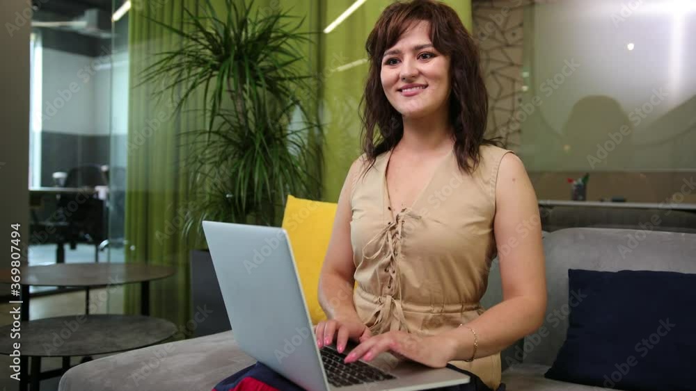 Shot of an attractive mature businesswoman working on laptop in her workstation. Woman using computer. Smiling beautiful brunette business lady. Getting down to work. Shot of an attractive mature businesswoman working on laptop in her workstation. Woman using computer. Smiling beautiful brunette business lady. Getting down to work.