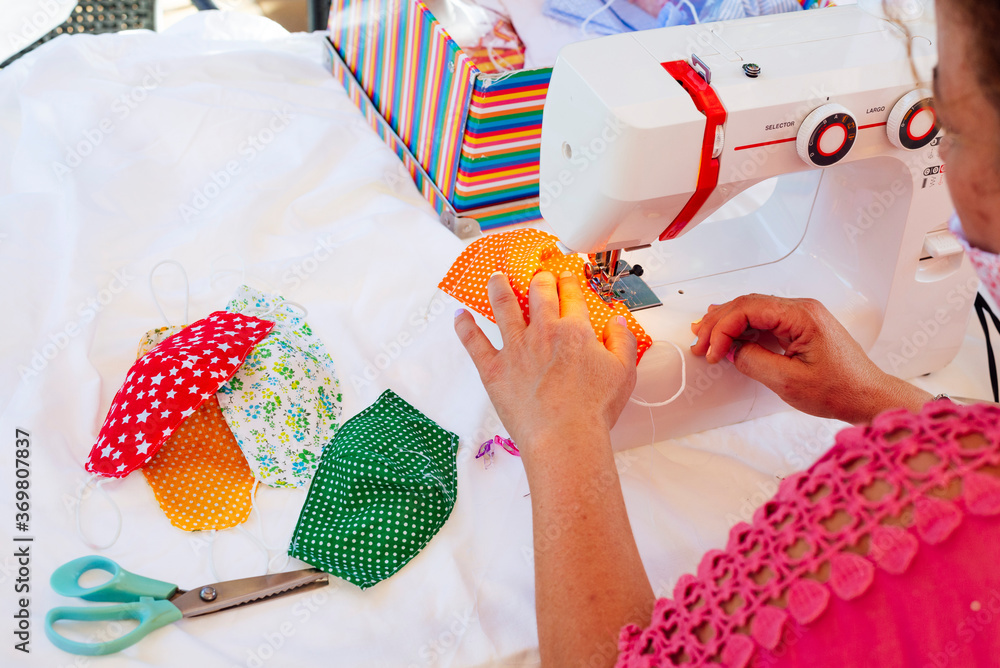 Fototapeta premium Woman sewing face masks at her home