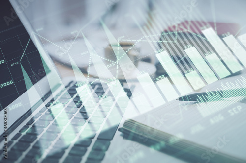 Double exposure of financial chart drawing and desktop with coffee and items on table background. Concept of forex market trading