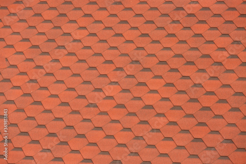 Fragment of a tiled roof illuminated by the sun