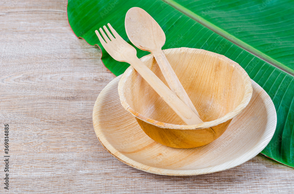 Kitchenware made from dried betel nut leaf palm, natural material. - obrazy, fototapety, plakaty 