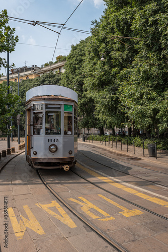 A tram travels in one of the streets of an Italian city