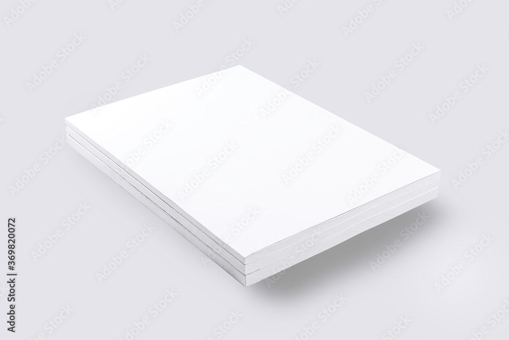 Stack of white blank magazines on gray backgrouns. Stack of white blank magazines on gray backgrouns.