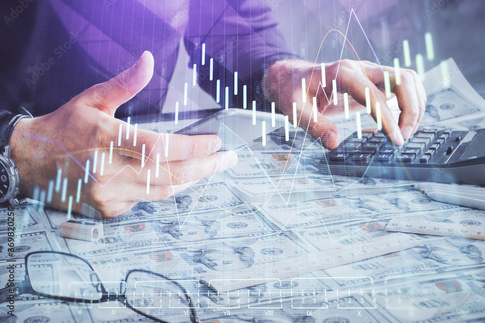 Double exposure of man's hands holding and using a digital device and forex graph drawing. Financial market concept. Double exposure of man's hands holding and using a digital device and forex graph drawing. Financial market concept.