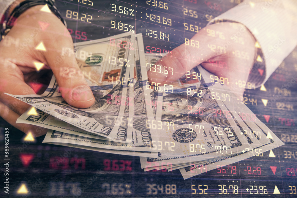 Multi exposure of financial graph drawing hologram and USA dollars bills and man hands. Analysis concept. Multi exposure of financial graph drawing hologram and USA dollars bills and man hands. Analysis concept.