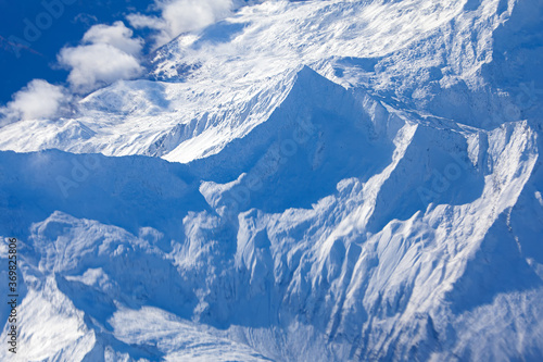 Glacier over the mountains . Peaks covered by snow . Alps in the winter 