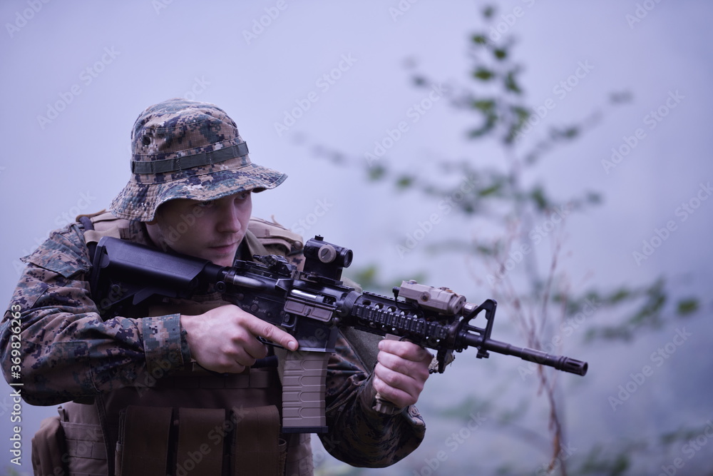 Fototapeta premium soldier in action aiming on weapon laser sight optics
