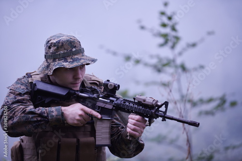 soldier in action aiming on weapon laser sight optics