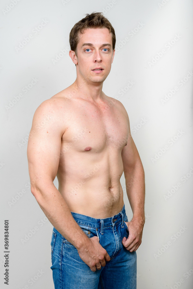 Fototapeta premium Portrait of handsome shirtless man against white background