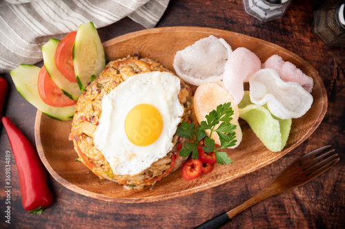 nasi goreng, indonesian fried rice on wooden plate