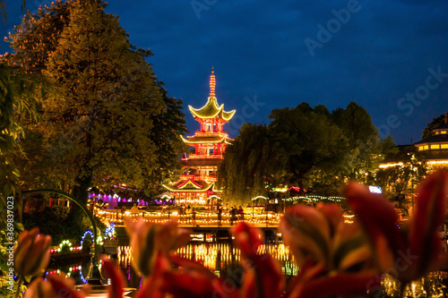 Obraz na plátně illuminated Chinese pagoda in a danish park at night
